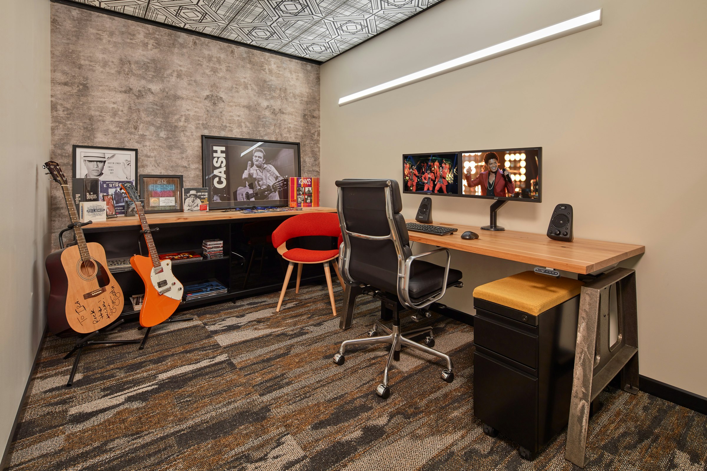 bmg office with acoustic buzzisking printed on the walls and guitars